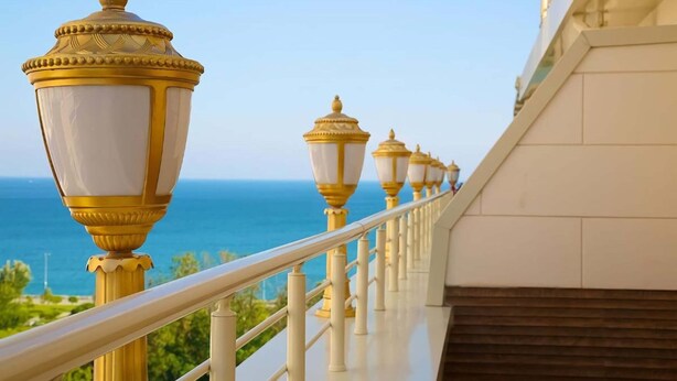 A balcony with a railing, a row of ornate street lamps, and a view of the sea. - Hotel Emirhan Palace (Istanbul)
