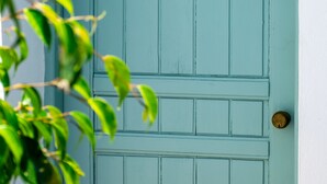 A teal door with a brass doorknob and a number '9' above it. - Kurmulis Studios (Chania)