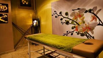 Cozy retreat with a single bed, floral mural, and staircase leading to an upper level.