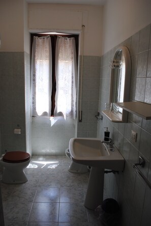 A bathroom with a toilet, sink, and shower. - Calciufetta B&B (Alghero)