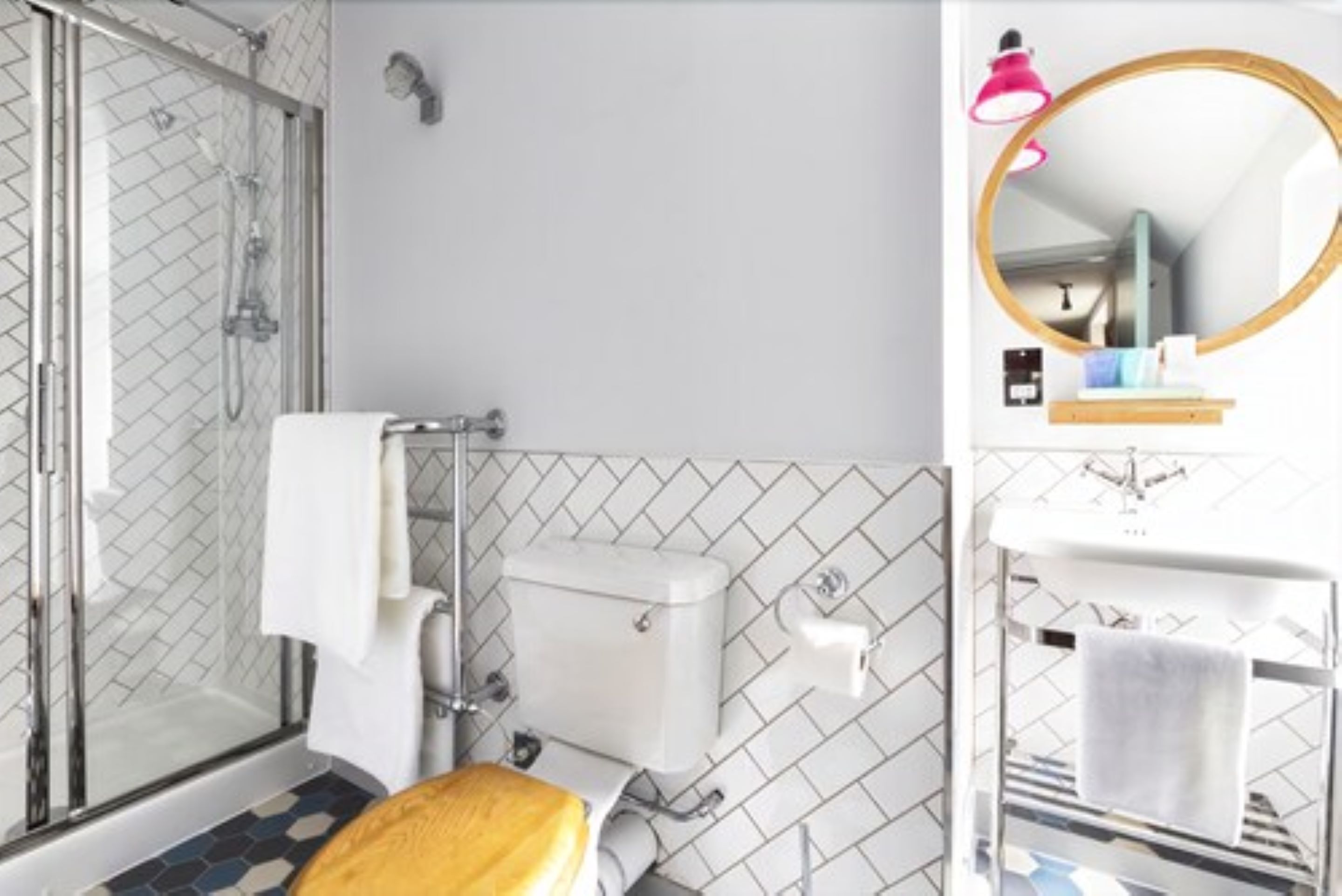 A bathroom with a shower, toilet, and sink.
