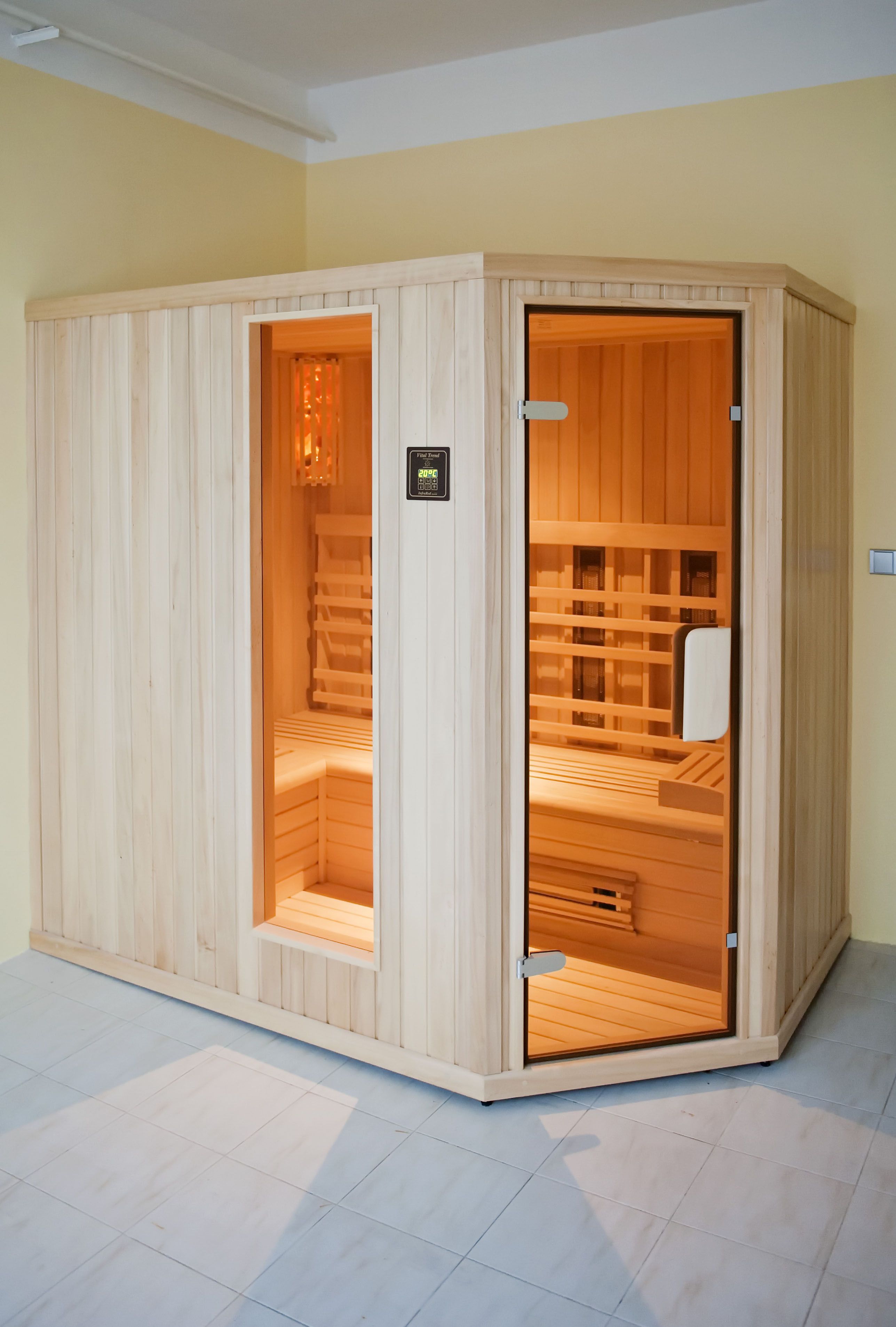 A wooden sauna with a sliding door, a bench inside, and a small sign on the door.