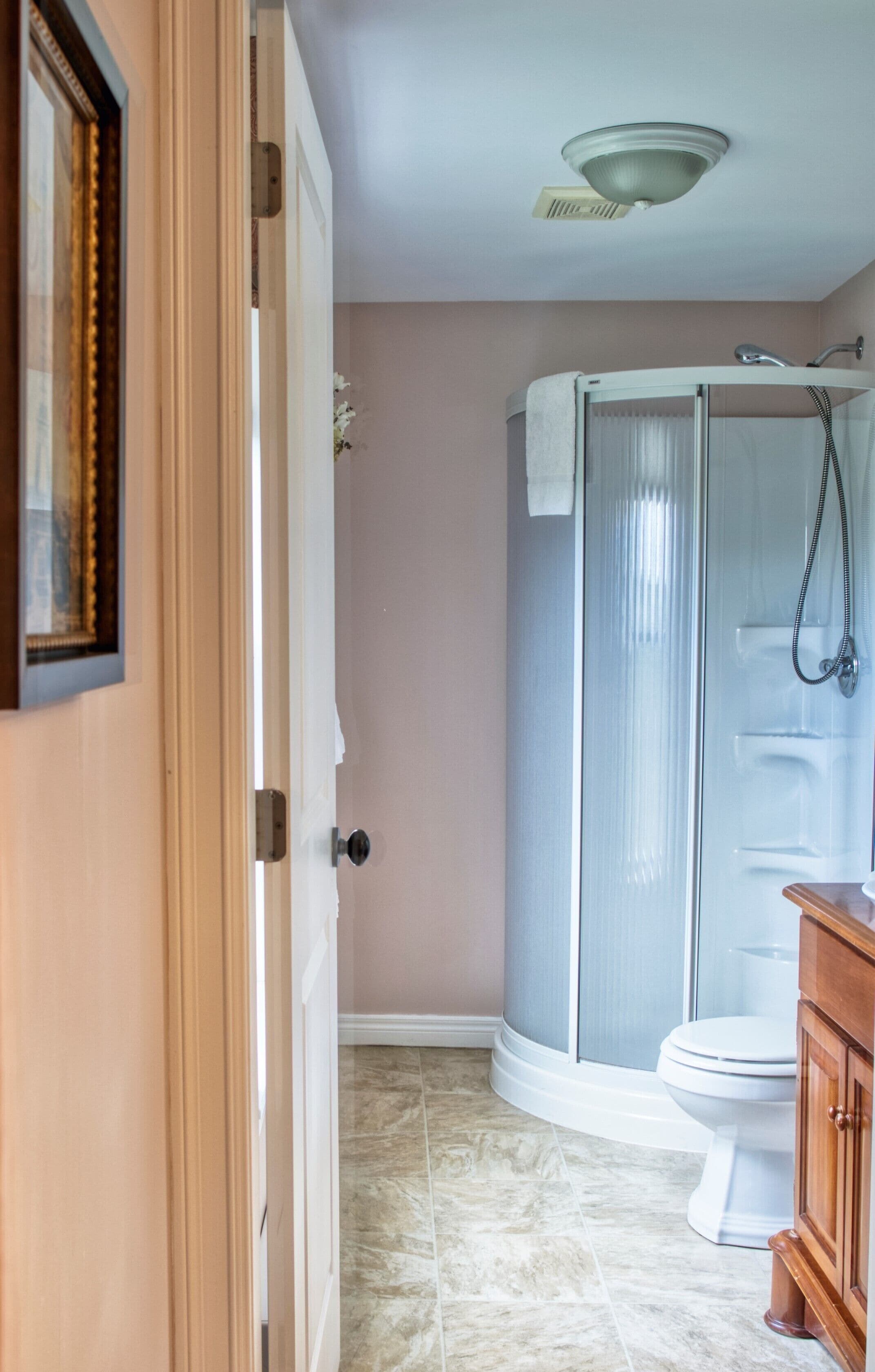 A bathroom with a shower, toilet, and vanity.