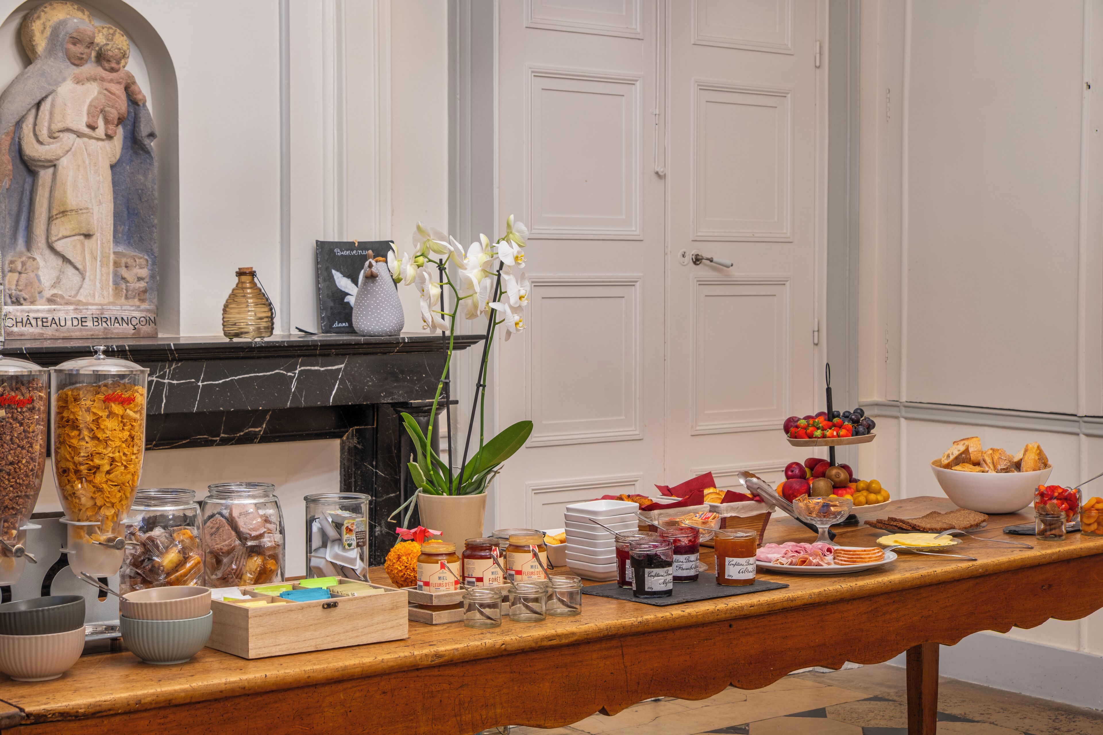A buffet table with various food items and condiments.