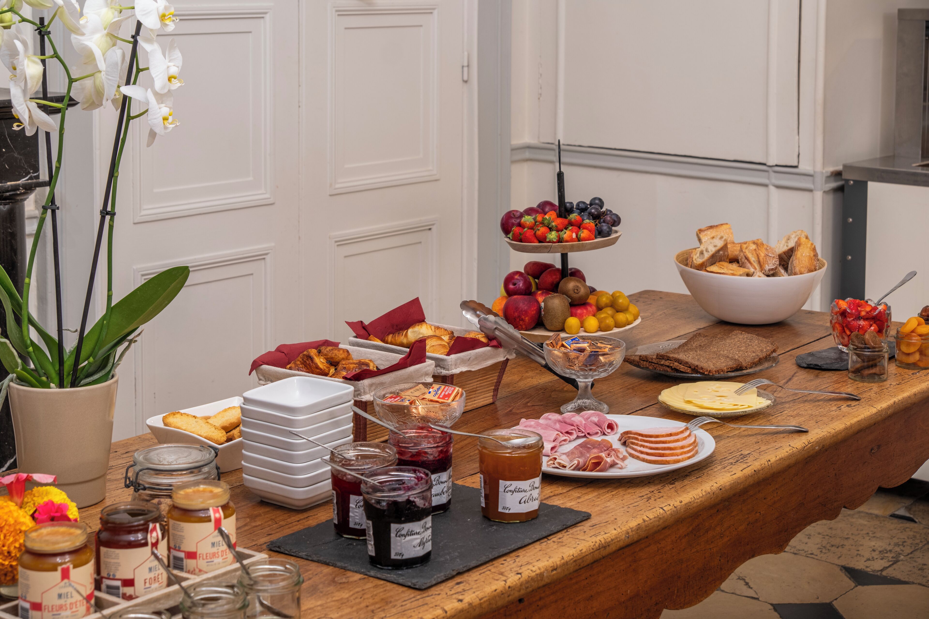 A breakfast buffet with various food items and condiments.
