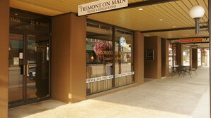 A hotel entrance with a sign reading "The Tremont on Main Hotel & Restaurants." - Tremont Inn on Main (Marshalltown)