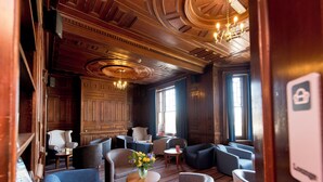 A hotel lobby with a classic design, featuring a mix of seating areas and a reception desk. - YHA Swanage - Hostel (Swanage)