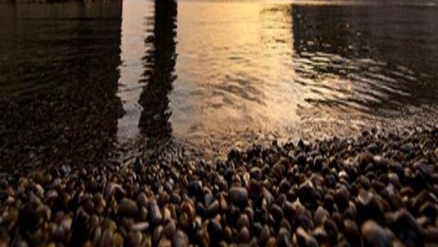 A natural rock formation with a narrow passageway, calm water, and a sunset in the background. - YHA Swanage - Hostel (Swanage)