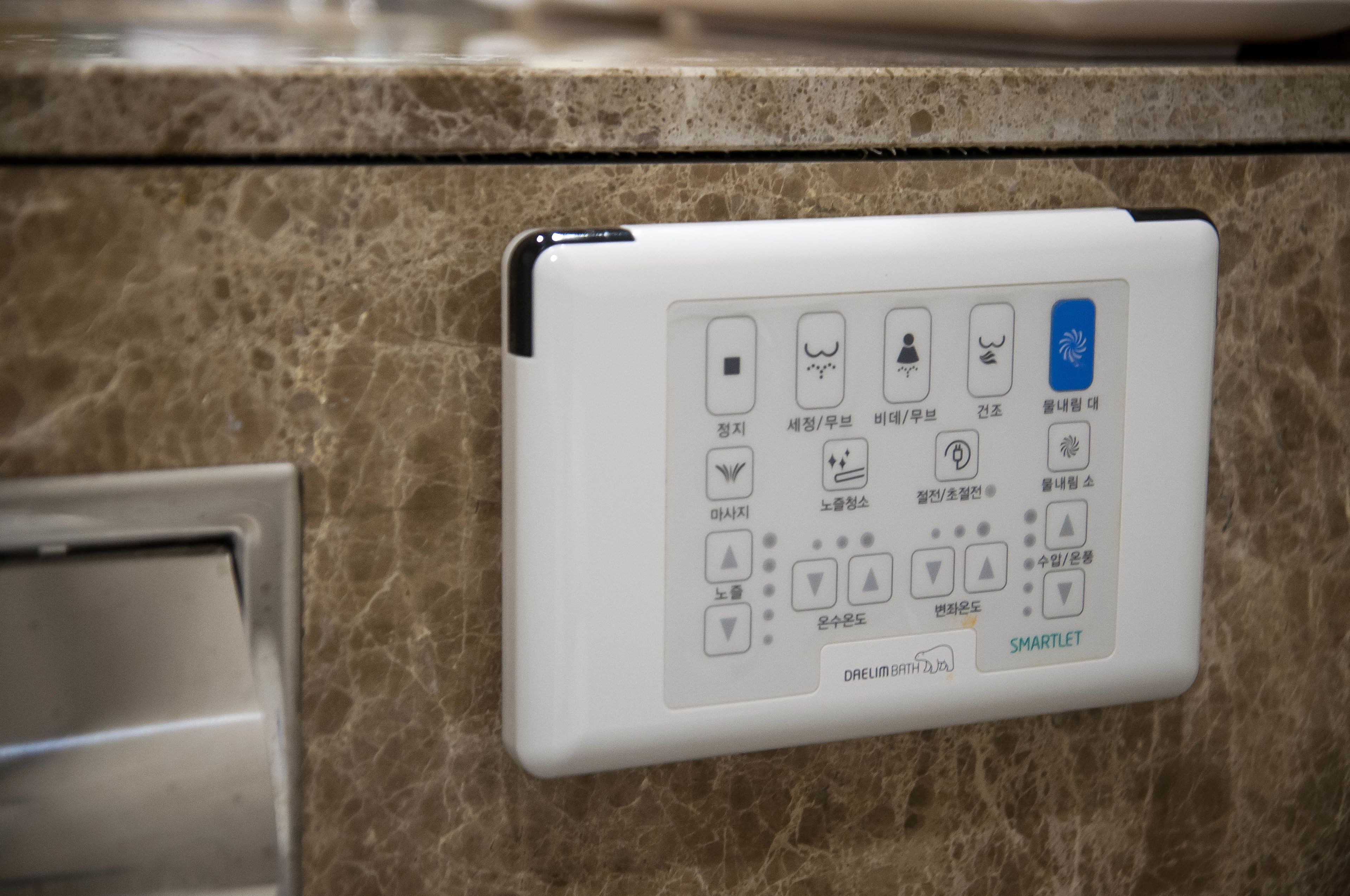 designer toiletries, hair dryer, slippers, bidet