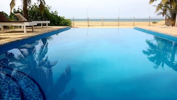 Outdoor pool, an infinity pool, pool loungers