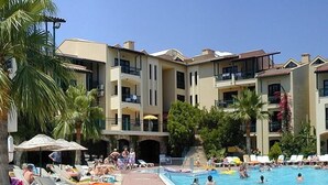 A hotel pool area with sun loungers and a swimming pool. - Club Turquoise Apartments (Marmaris)