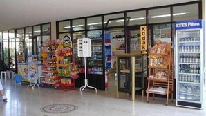 A store with a variety of products, including snacks and beverages. There are signs for 'Kodak' and 'ETES Pilen'. - Club Turquoise Apartments (Marmaris)