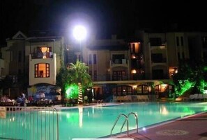 Relax by the pool with lounge chairs and umbrellas.