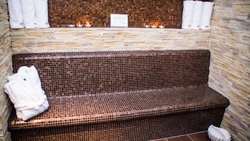 Relax on the mosaic-tiled bench, accompanied by plush towels.
