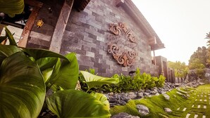 A building with a stone facade and decorative wall art. - Ipoh Bali Hotel (Ipoh)