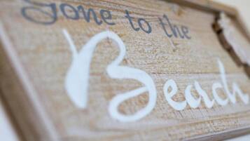 A wooden sign with the text "Gone to the Beach".