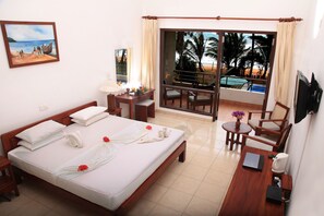 Deluxe Double Room, Beach View | Minibar, in-room safe, desk, iron/ironing board