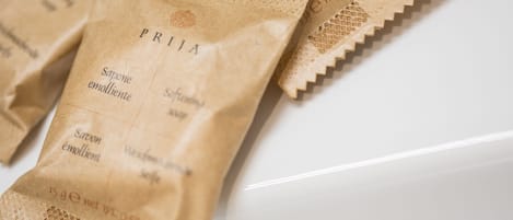 A close-up of paper bags with the text "PRITA" and "Savon emolliente" printed on them.