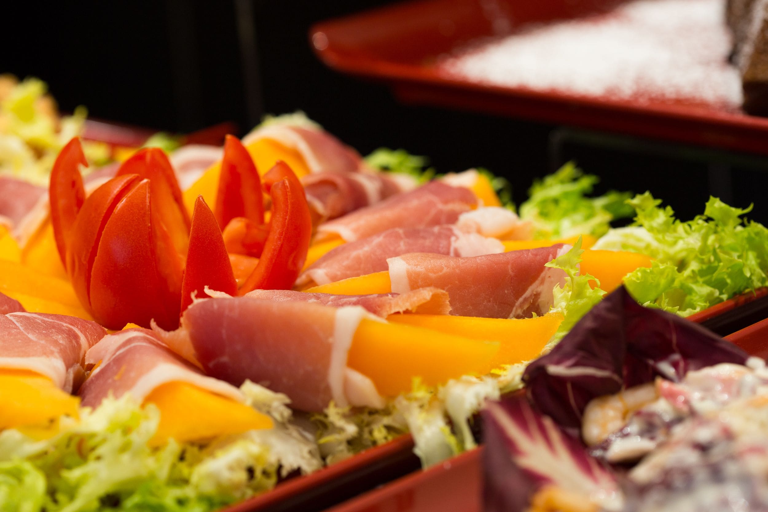A buffet with various meats and vegetables.