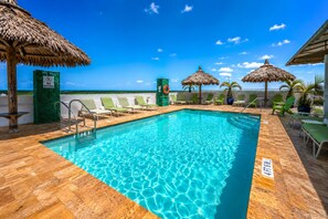 A pool area with a clear blue pool, lounge chairs, and a view of the ocean. - Rooftop Resort - Clothing Optional - Adult Only (Hollywood)