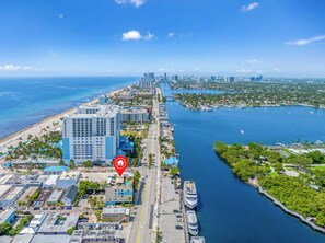 A coastal cityscape with a marina, high-rise buildings, and a beach. - Rooftop Resort - Clothing Optional - Adult Only (Hollywood)
