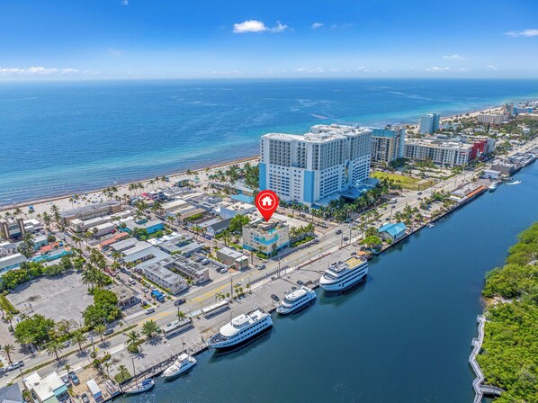 A coastal cityscape with a marina, hotels, and a clear view of the ocean. - Rooftop Resort - Clothing Optional - Adult Only (Hollywood)