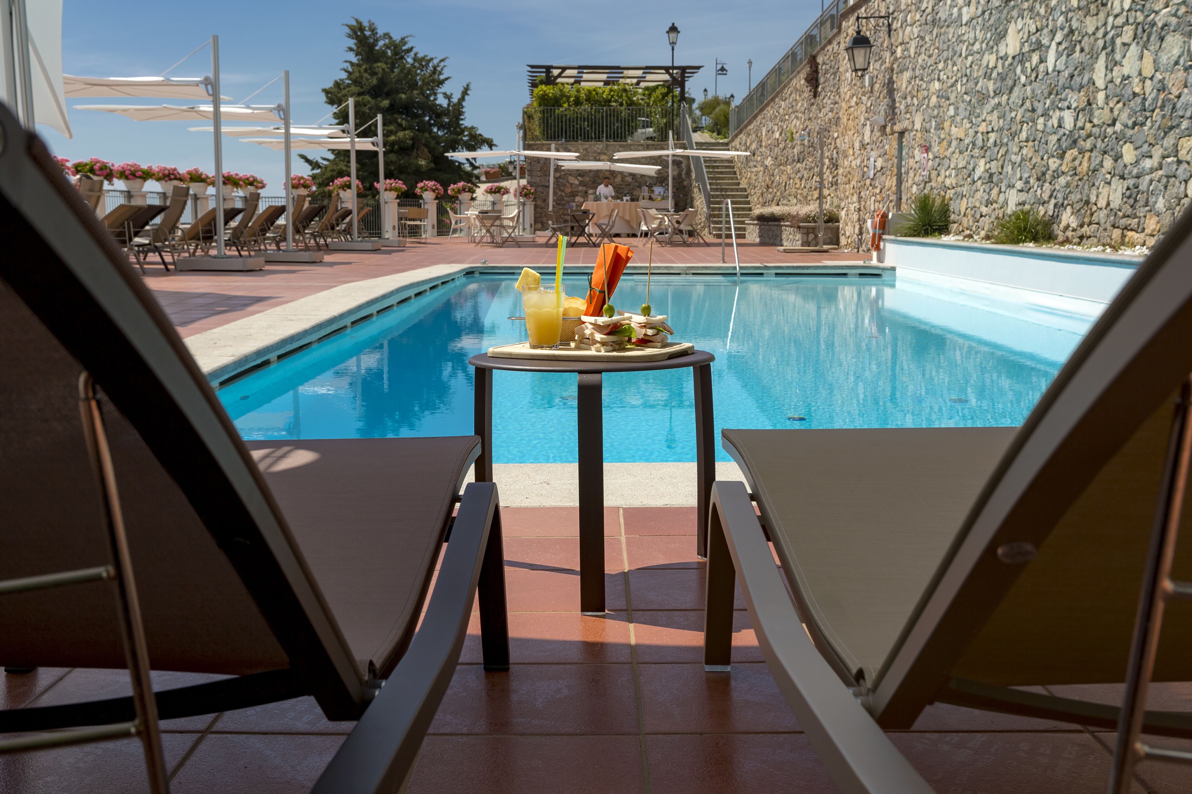 outdoor pool, open 9:30 am to 5:30 pm, pool umbrellas, pool loungers