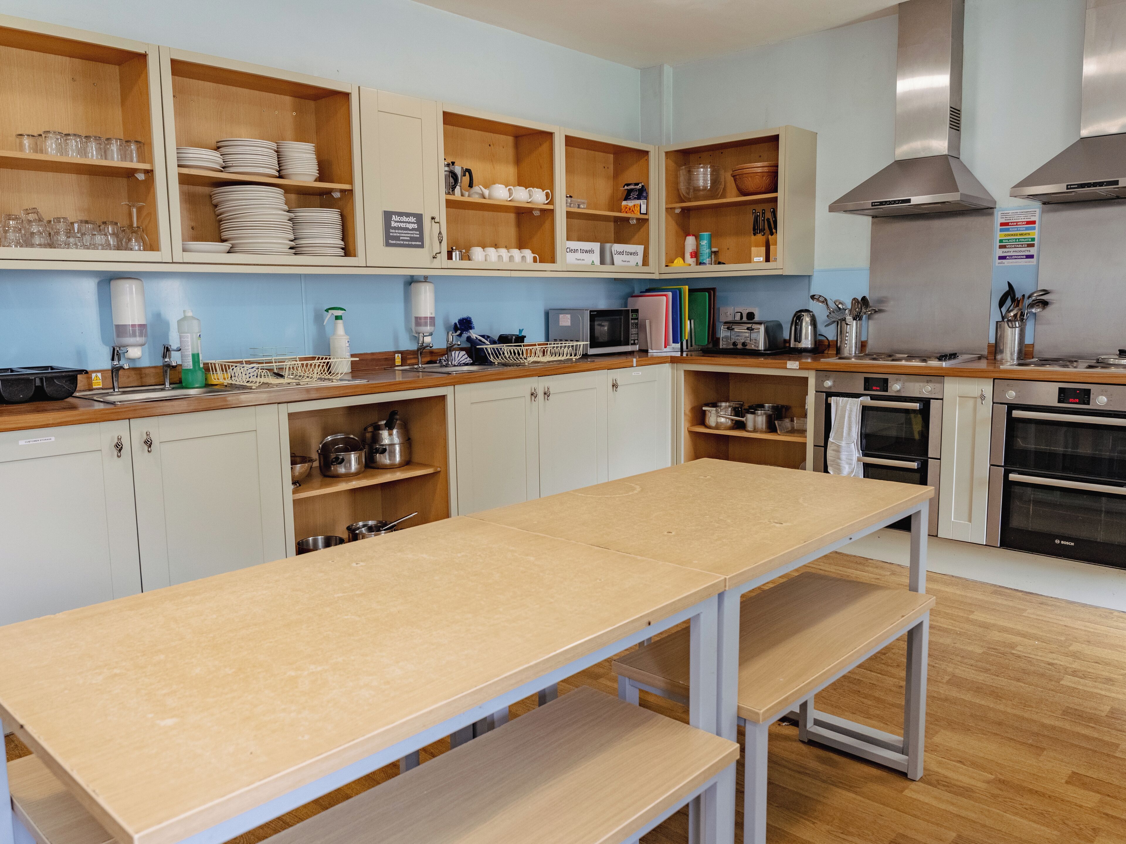 A modern kitchen with wooden cabinets, stainless steel appliances, and a central island.