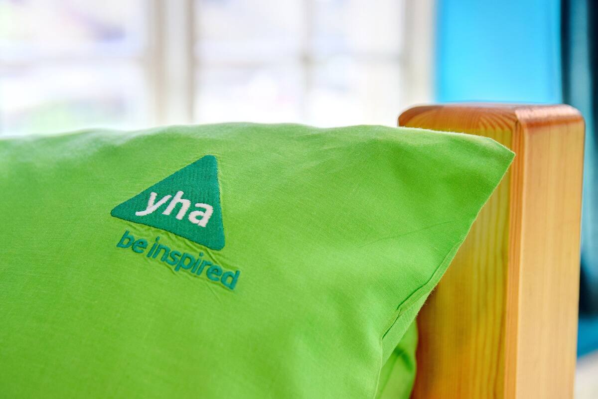 A green pillow with a logo and text.