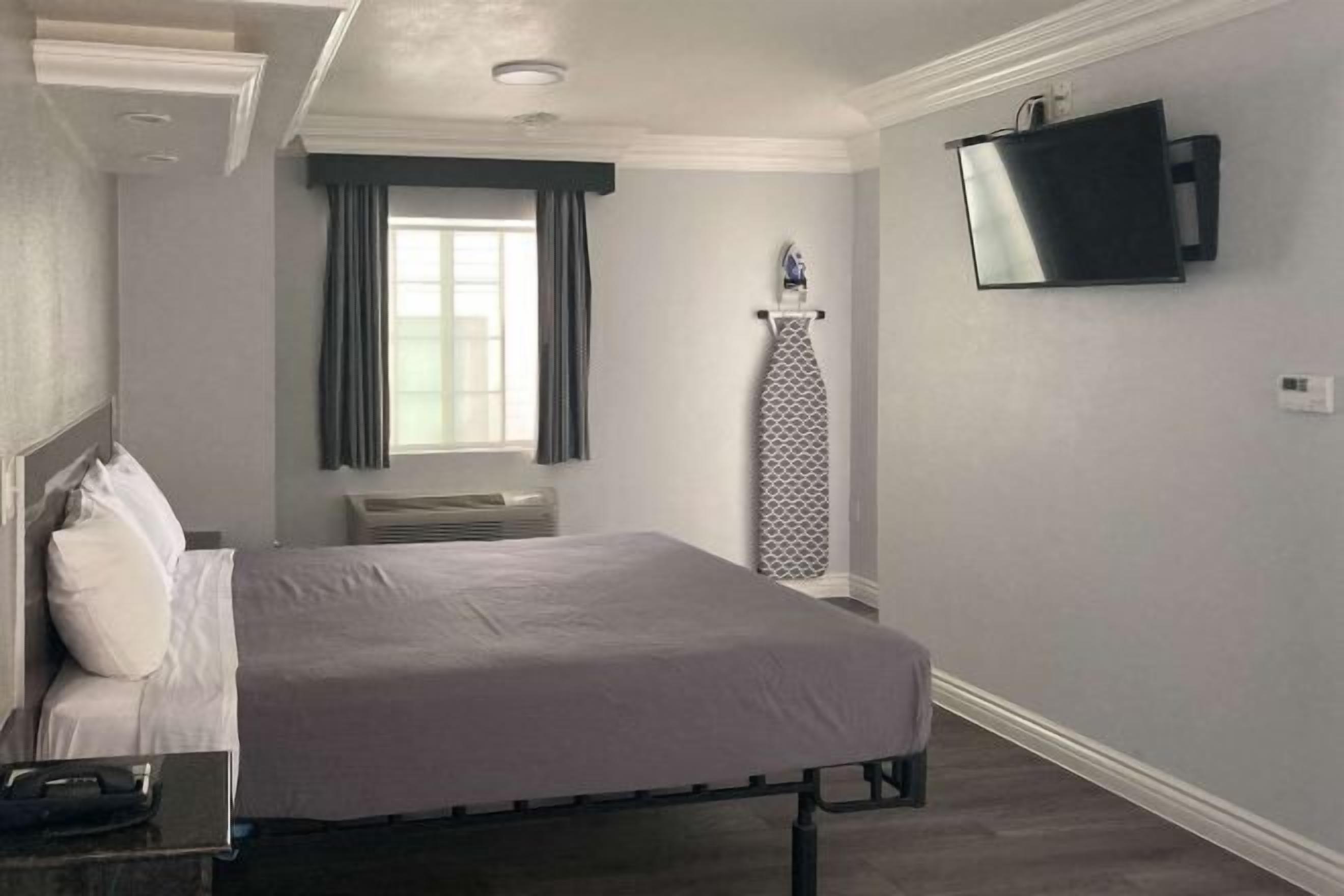 Desk, laptop workspace, blackout drapes, iron/ironing board