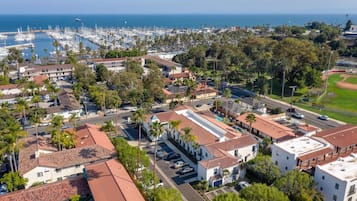 A coastal town with a marina, residential buildings, and a baseball field.
