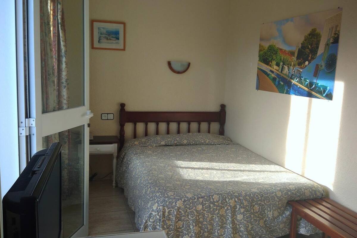 Desk, blackout curtains, bed sheets
