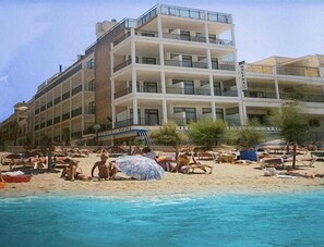 A multi-story hotel with balconies, a beach in the foreground, and a clear sky. - Marina Playa de Palma (Playa de Palma)