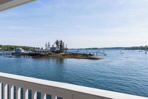 A waterfront property with a dock, a small building, and a pier extending into the water.