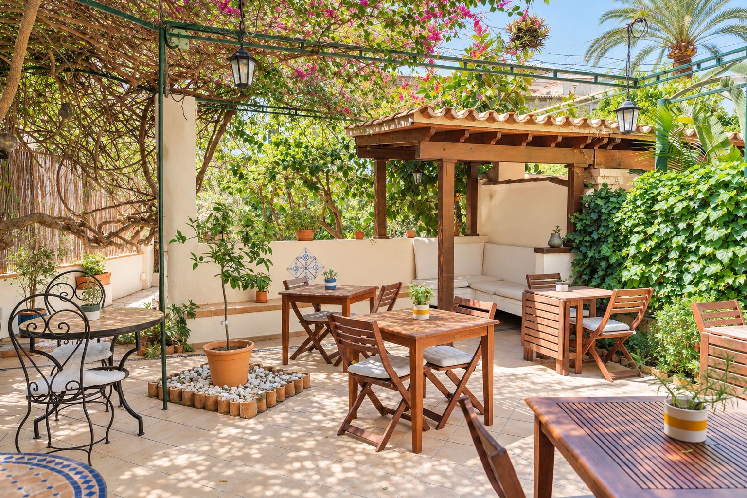 An outdoor patio with wooden furniture, potted plants, and a pergola.