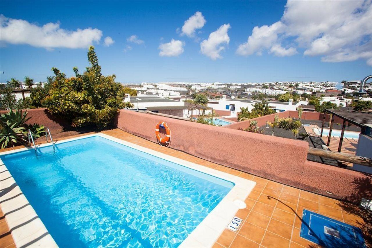 A rooftop pool with a clear view of the cityscape in the background.