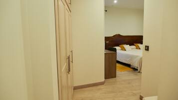Un dormitorio con una cama de madera, una mesita de noche y un armario.