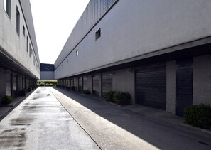 A modern building with a long, narrow corridor and multiple garage doors. - Zouk Hotel - Adults Only (Alcala de Henares)