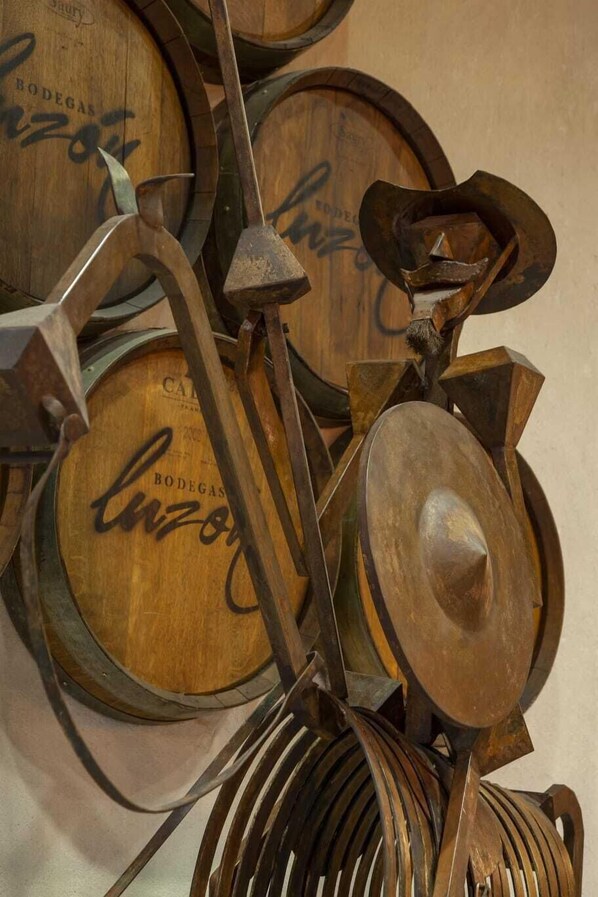 A collection of wooden barrels with metal fixtures, likely part of a wine cellar or storage area.