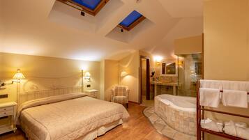 A bedroom with a bed, bedside tables, a chair, a glass-enclosed bathtub, and a towel rack.