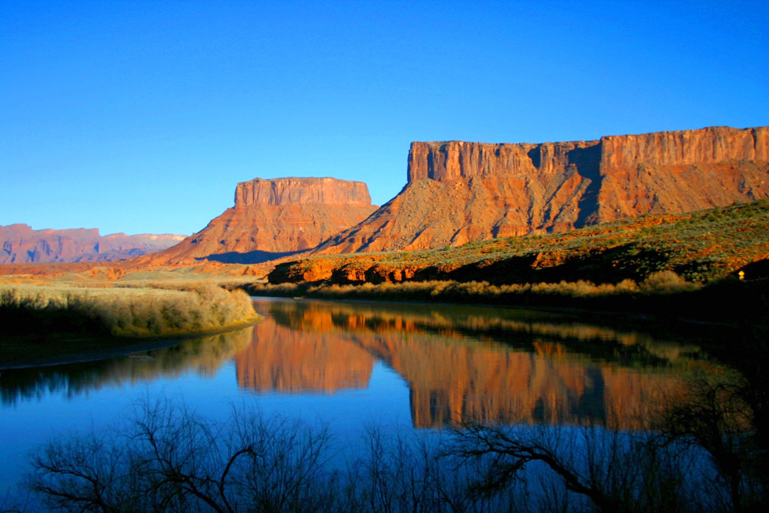 A river reflecting a canyon landscape.