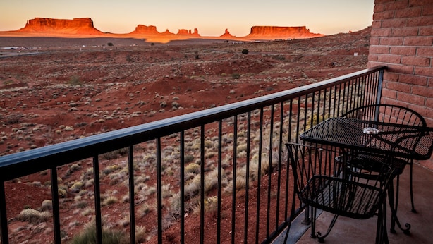 A balcony with a view of red rock formations.