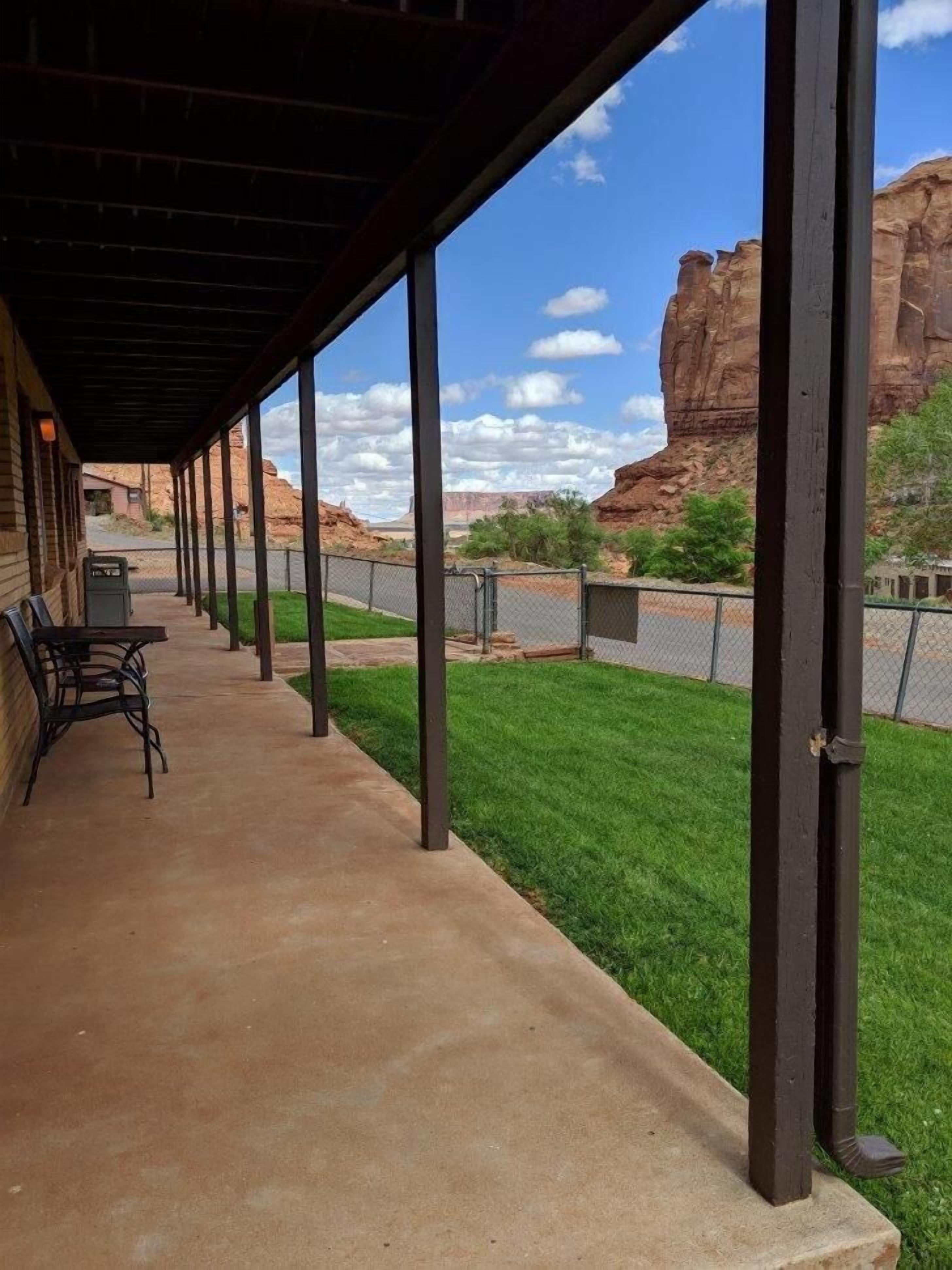 A covered patio with a view of red rock formations.