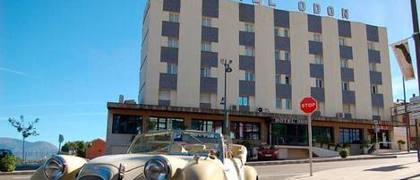 Un hotel llamado "HOTEL ODO" con una señal de stop en la entrada.