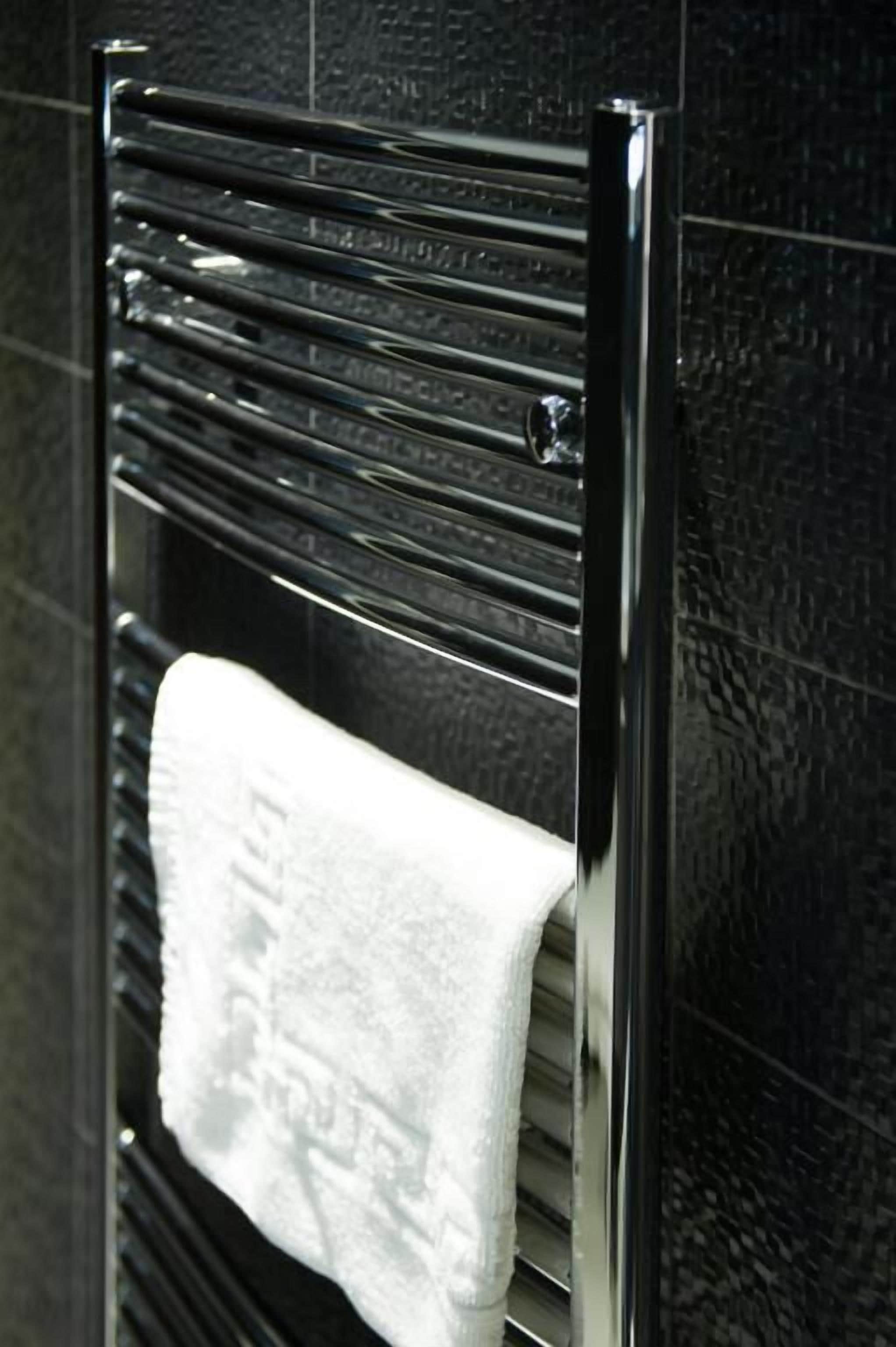 A towel rack with a white towel hanging on it.