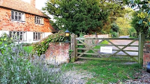 A brick house with a wooden gate labeled "Entrance".