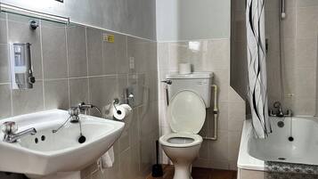 A bathroom with a sink, toilet, and bathtub.
