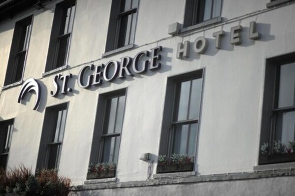 The exterior of St. George Hotel with a prominent sign and windows.