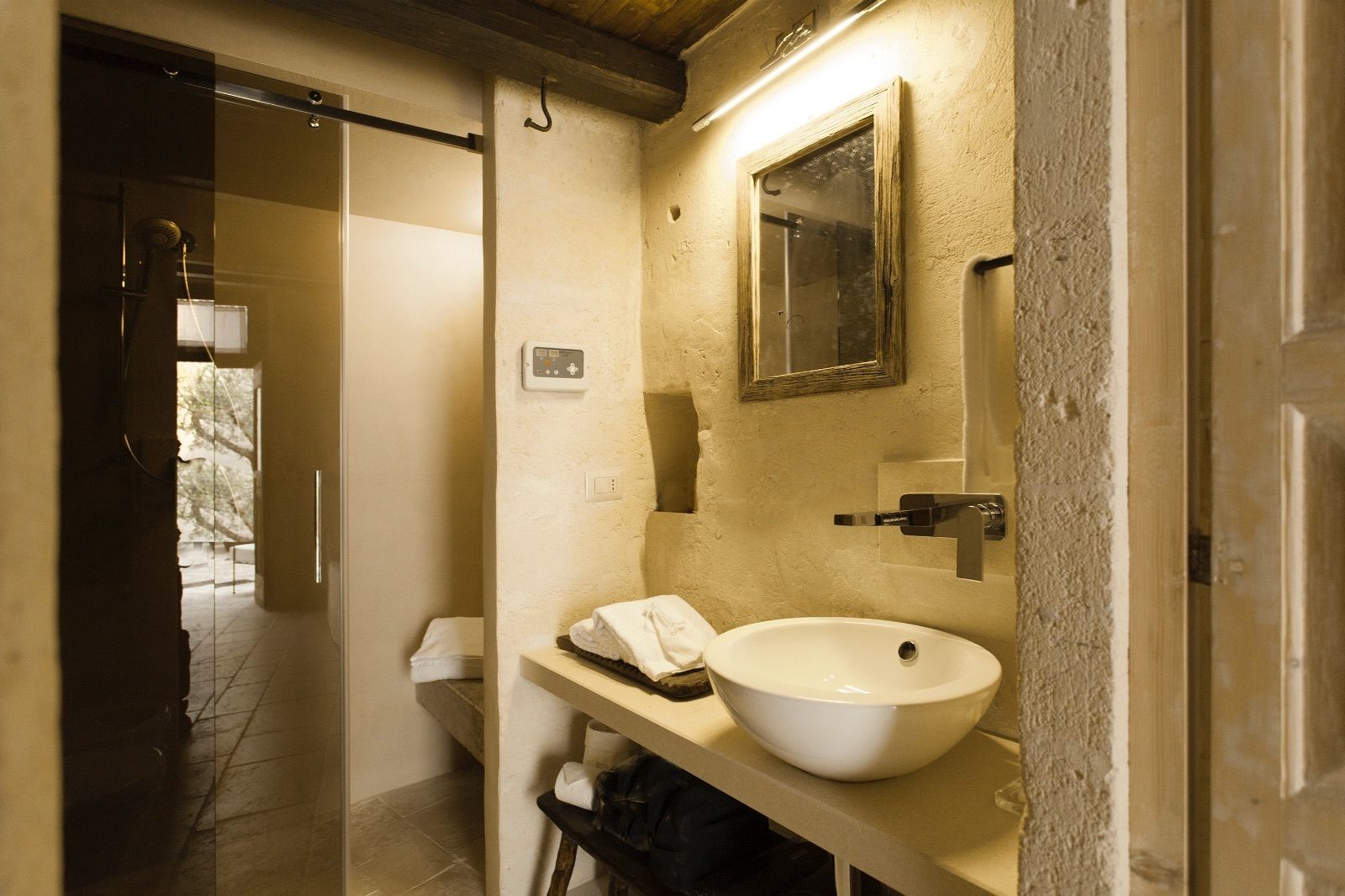 A bathroom with a white sink, a mirror, and a towel rack.