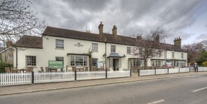 A traditional pub with a white facade, multiple windows, and a sign indicating 'The Brewers' as the name. - Two Brewers by Chef and Brewer Collection (Kings Langley)